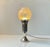 A small restaurant table light executed in silver plated brass and featuring a spherical shade in etched hand-blown glass....