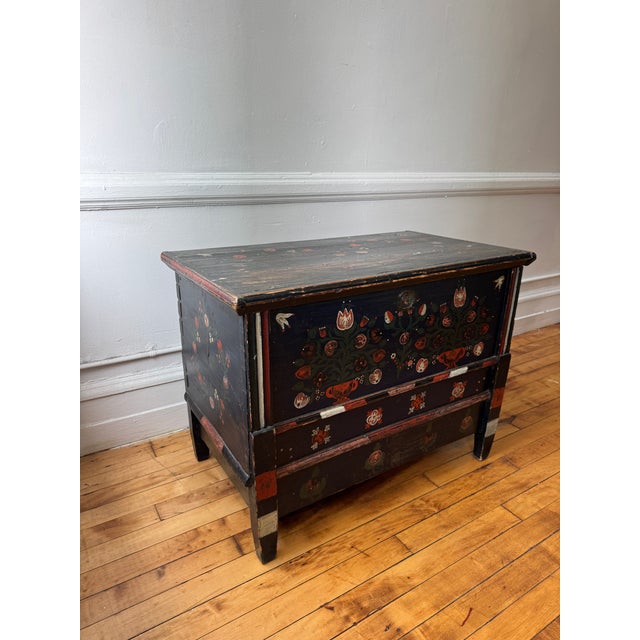 A late 19th century Scandinavian blanket chest, hand-painted with traditional floral motifs in deep navy with red, cream,...