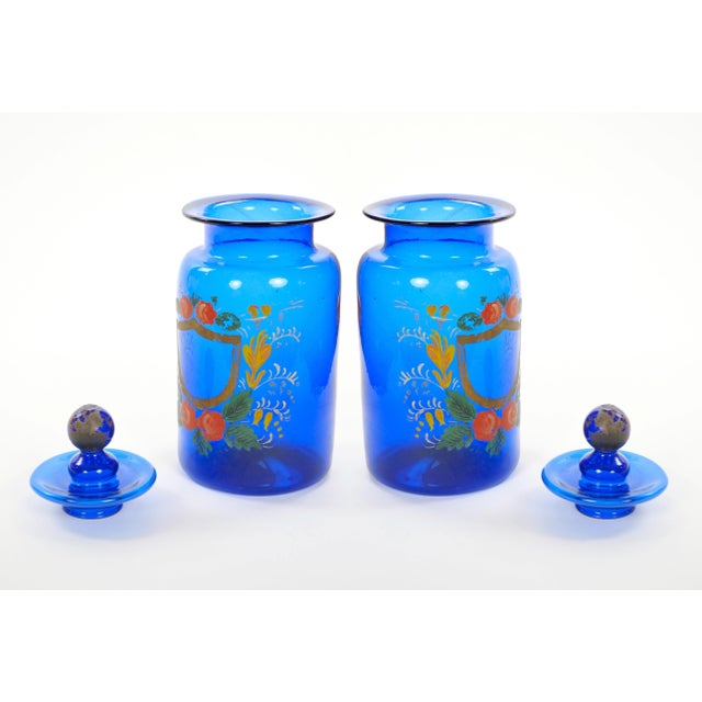 A beautiful pair of tall Italian apothecary jars with covers, crafted in Italy during the mid-20th century and showcasing...