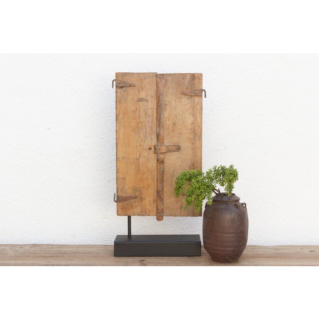This original 19th-century Indian window is a captivating piece of history, crafted from durable teak wood and featuring a...