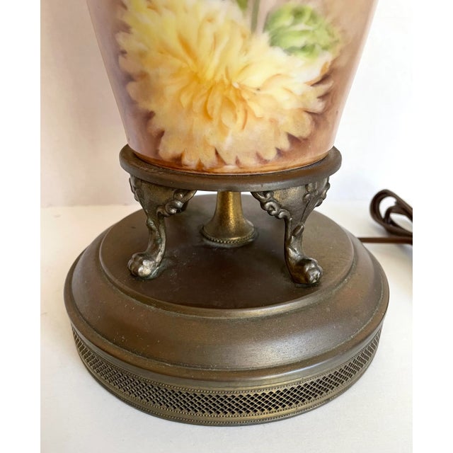 Here is a one-of-a-kind lamp that was hand-painted with a stunning, colorful floral bouquet. The flowers are a...