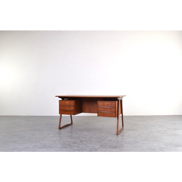 A Danish desk designed by Svend Åge Madsen for H.P. Hansen, created in the 1960s. The desk is crafted from teak, a...
