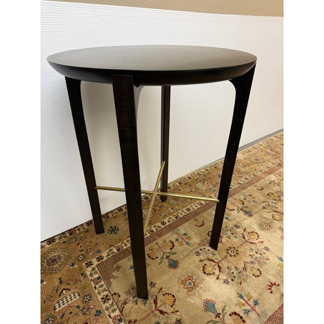 Design Plus Gallery presents a Sculptural Side Table of Walnut Wood and Brass Accents. The table offers a cradled tabletop...