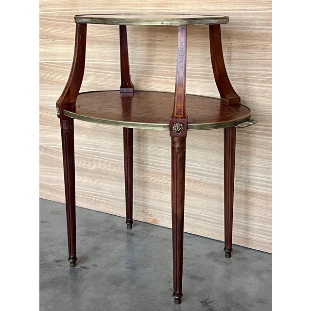 Attractive French Louis XVI style dessert stand, circa 1940s. Two oval tiers; the top with grey marble and brass gallery...