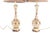 A dramatic and highly decorative pair of monumental Hollywood Regency table lamps. Each lamp features an elegant,...