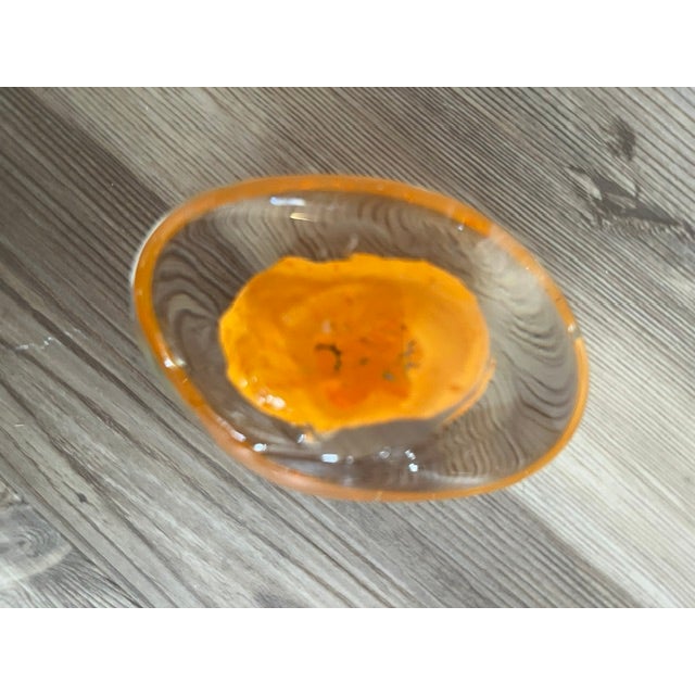 Murano blown glass style paperweight. Clear with an orange center