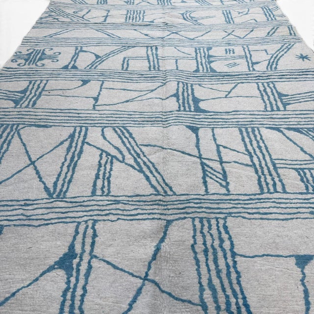 This modern Central Asian felt rug showcases a refined and architectural design language. The composition is defined by...