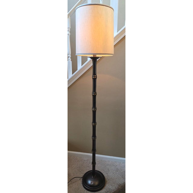 Striking vintage faux bamboo floor lamp, capturing the essence of mid-century Hollywood Regency and Chinoiserie design....