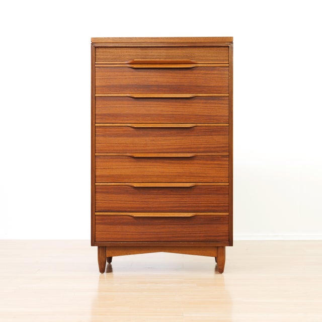 This elegant pair of mid-century teak tallboy chests by White &amp; Newton beautifully exemplifies the clean lines and...