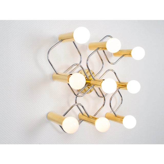 A stunning nine-light flush mount light fixture in brass and chrome can be used as a wall or ceiling light. Design:...