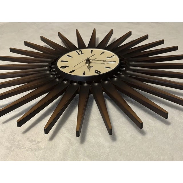Add a striking retro statement to your space with this authentic SYROCO sunburst wall clock, a true icon of Mid-Century...