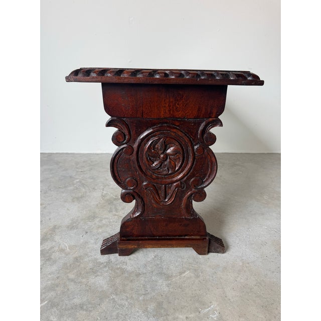 Striking vintage Italian Renaissance-style coffee table or bench, crafted from solid wood and richly detailed with deep,...