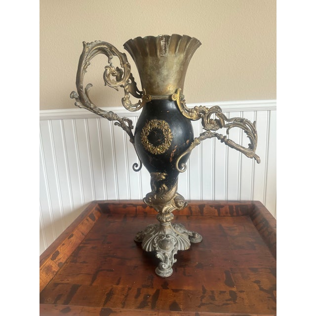 A 19th-century Rococo Style Figural Neptune Mantel Vase / Urn manufactured by Bradley & Hubbard Manufacturing Company....