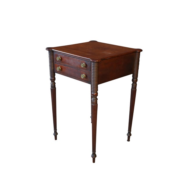 This antique American Federal or Sheraton-style side / end table or nightstand is crafted from solid mahogany with a rich,...