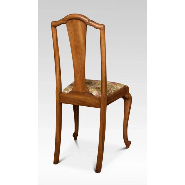 Pair of walnut side chairs the shaped back splat. Above drop-in upholstered seats and standing on cabriole supports....