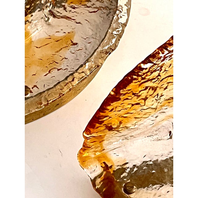 A splendid and rare pair of large wall sconces made in murano by the historic mazzega glassworks during the 1970s. these...