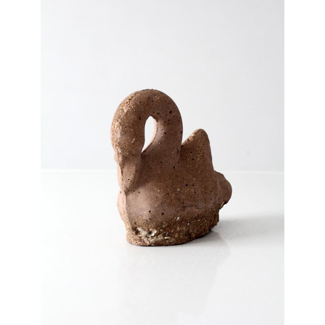This vintage handmade swan sculpture features a looping neck, sculpted wings, and a heavily textured cement composition...