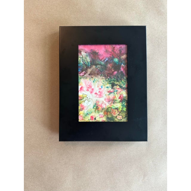 A richly layered abstract watercolor featuring luminous pinks, mossy greens, smoky charcoal tones, and delicate organic...
