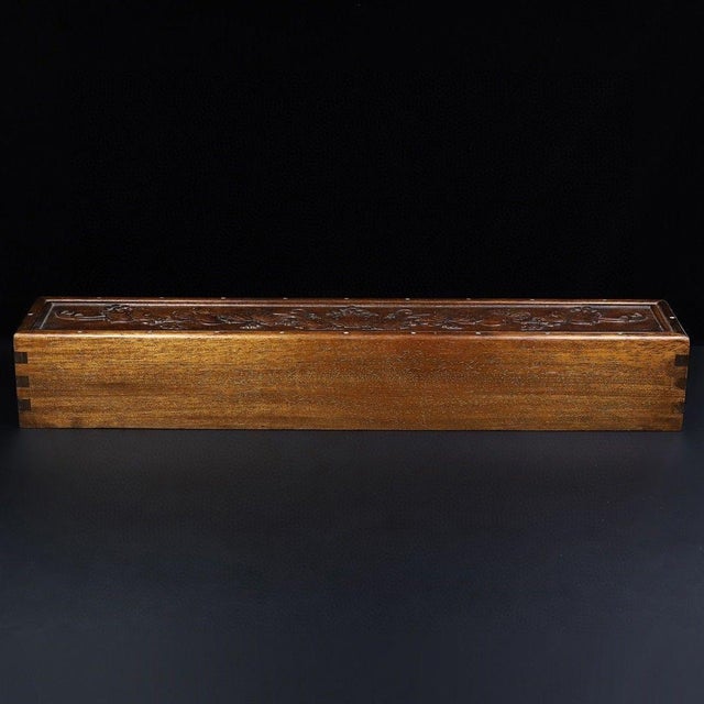 A beautifully crafted long Chinese wooden box, likely made of Huali (rosewood), designed for storing scrolls or...