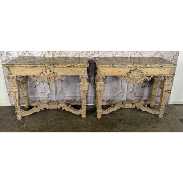 A magnificent pair of French Baroque Revival console tables, embodying the grandeur of a Louis XIV château with a...
