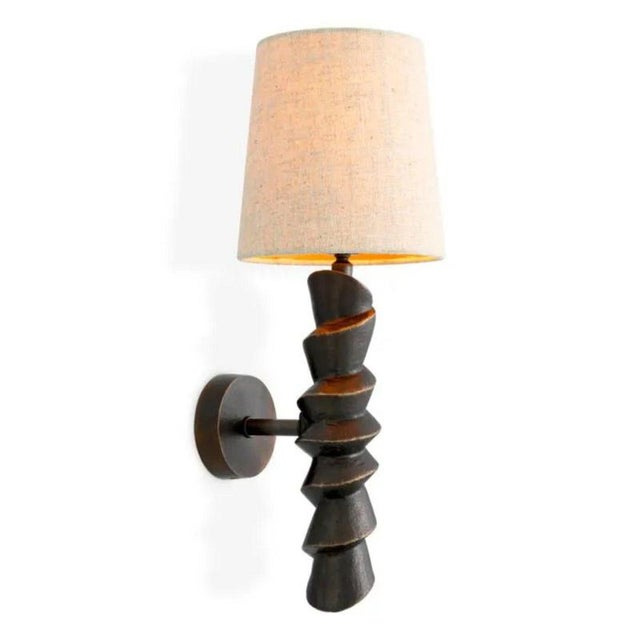 Pair of contemporary bronze finish wall lamp that combines a sculptural cast aluminium body with a bronze highlight finish...