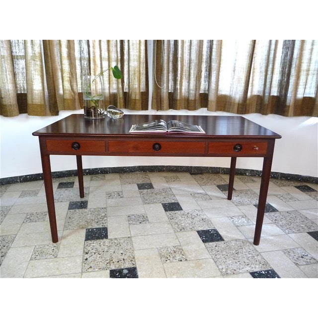 This writing desk was designed by Hans J. Wegner for the Danish manufacturer PP Møbler in 1955. The desk is a piece of...