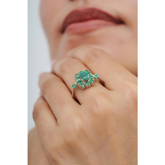 This 1.58 carat emerald cluster ring is crafted in 925 sterling silver and features an octagon cut emerald surrounded by...