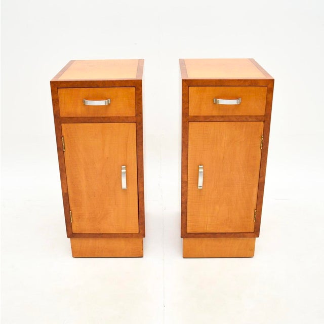 A sleek and stylish pair of Art Deco satinwood and walnut bedside cabinets. They were made in England, they date from the...