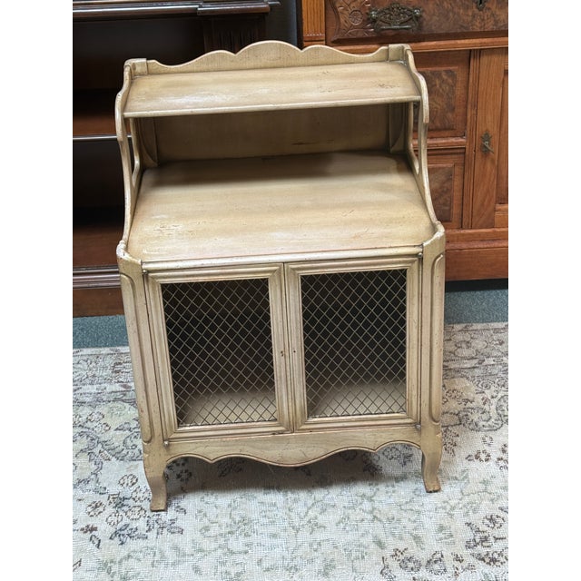 Design Plus Gallery presents a Vintage Nightstand by John Widdicomb. The nightstand has a light wash and distressed finish...
