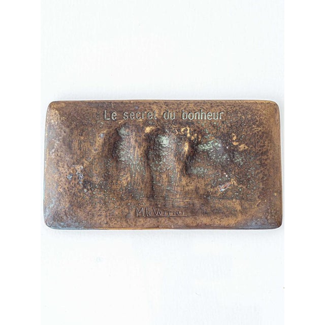 Elegant Art Deco bronze vide-poche by Max Le Verrier, titled “Le secret du bonheur” and featuring the timeless motif of...