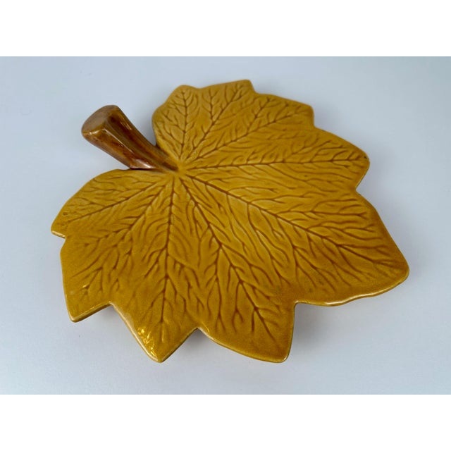 Ochre yellow ceramic serving plate. Vallauris. Stamped. In beautiful condition. Minor chipping on a few leaf tips (see...