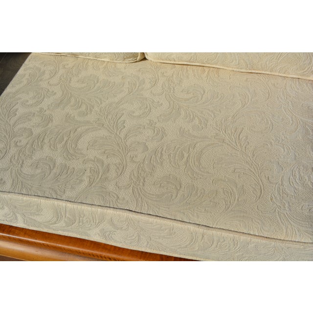 This is a sturdy & solid wood, possibly elm, couch. Great shape overall. I saw one identical that was listed as Michael...