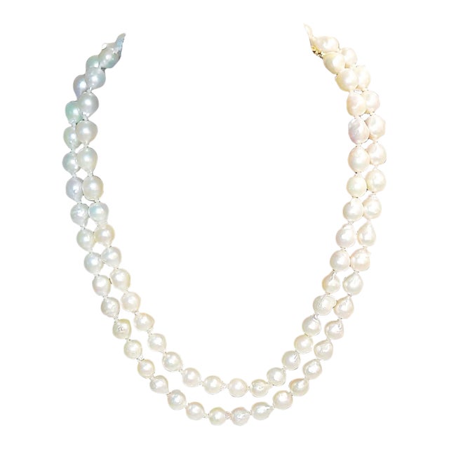 Timeless elegance, a 36" strand of semi-baroque cultured pearls with a beautiful color and deep luster, with 14k gold...