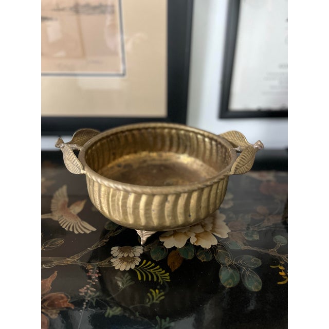A lovely, vintage, hammered brass, footed cachepot with botanical handles. Use it for your centerpiece botanicals, or as a...
