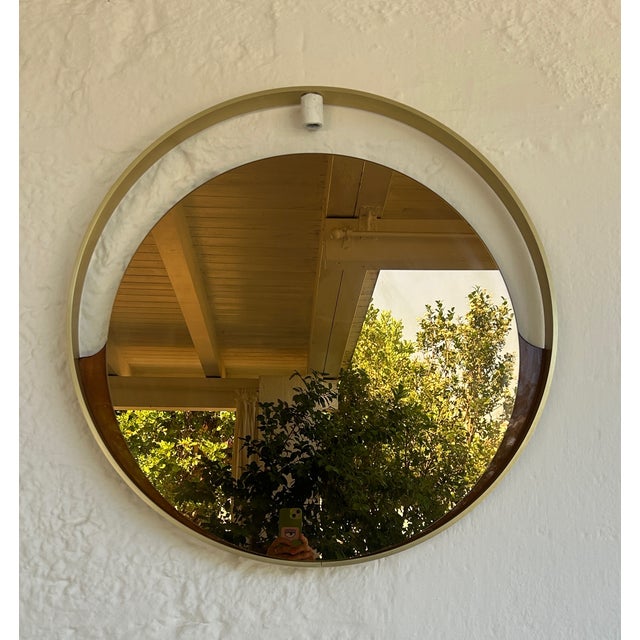 mirror with brushed brass frame and smoked mirror surrounded by wood, produced by modernindustria in the 70s This piece is...