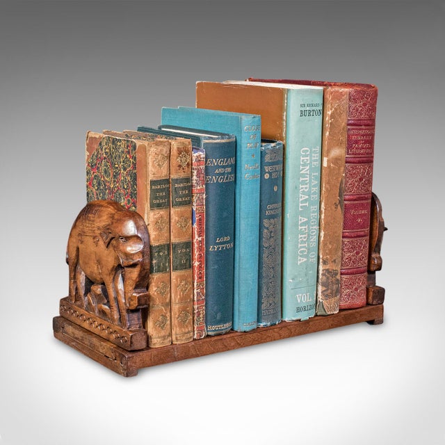 This is a vintage carved elephant book slide. An Anglo-Indian, mahogany home library stand, dating to the Art Deco period,...