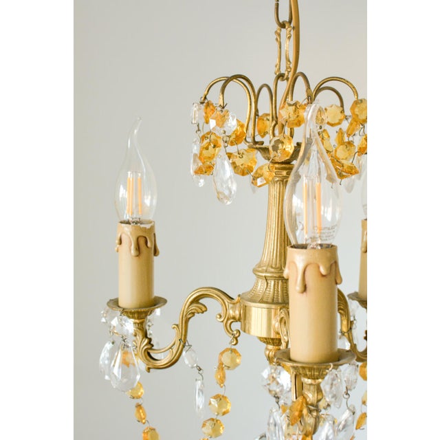 Small French Brass Chandelier in Amber Crystal, 1960s, in Very Good conditions. Designed 1960 to 1969 Up to 250V...