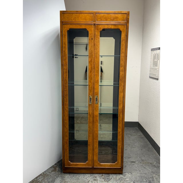 Design Plus Gallery presents a Vintage Campaign Style Curio Display Cabinet. The cabinet is detailed with burl wood...
