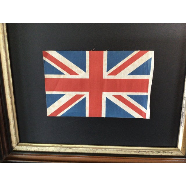 Vintage Union Jack Flag set in an age related frame and under glass. Frame size is 12”x 10”. All measurements are...