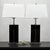 These black synthetic leather and chrome block table lamps make a bold design statement, capturing the spirit of...