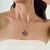 Crafted in 925 sterling silver, this celestial-inspired pendant features 2.53 carats of baguette and round-cut natural...