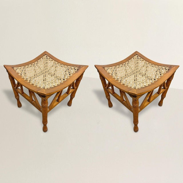 A handsome pair of early 20th-century English Thebes stools, embodying the timeless elegance of Egyptian-inspired design....