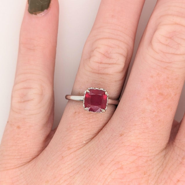 This beautiful ring features a sparkling red ruby in 14k white gold with a hidden diamond halo. A ring design perfect for...