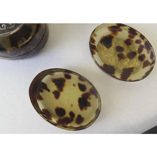 Set of four nesting oval boxes. Largest measures 3" by 2 1/4" by 1 1/4". Silver tops are not marked by tests for silver.