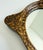 Elegant small-scale accent wall mirror with scalloped wood frame, finished in faux tortoise shell paint. Produced in the...