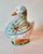 A fabulous vintage white goose tureen. She is wearing a colorful floral tied scarf. Made in Italy.
