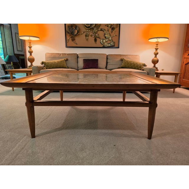 This beautiful Mid-Century coffee table boasts an exquisite slab of Portuguese fossil marble, sharing warm neutral earth...