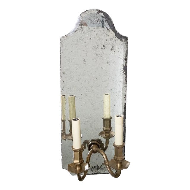 Beveled mirror and cast brass two-arm sconces For Sale
