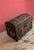 Antique travel trunk with a domed lid, wooden slats, and iron fittings dating from the late 19th century. An ideal piece...
