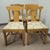 A set of four vintage American dining chairs in solid pine, featuring the classic fiddleback splat and turned front legs....
